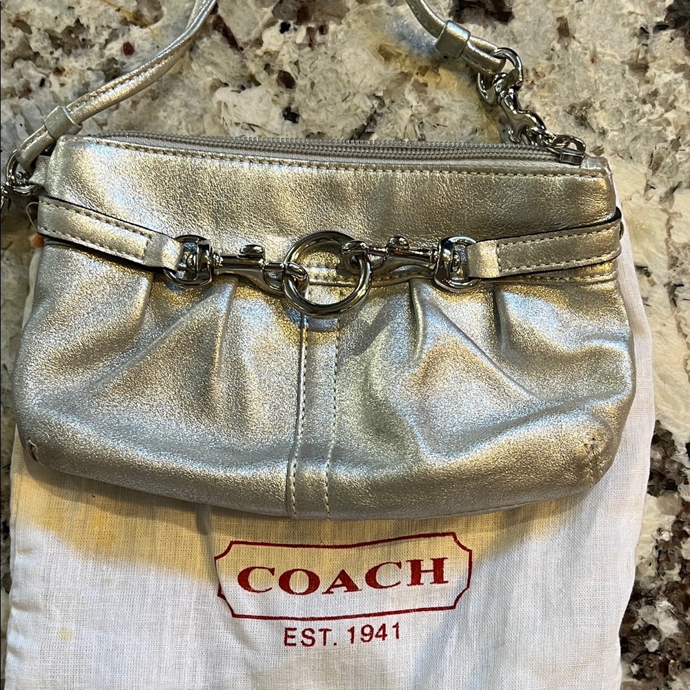 Coach Silver leather wristlet. Pre-Owned Condition-Very Good.